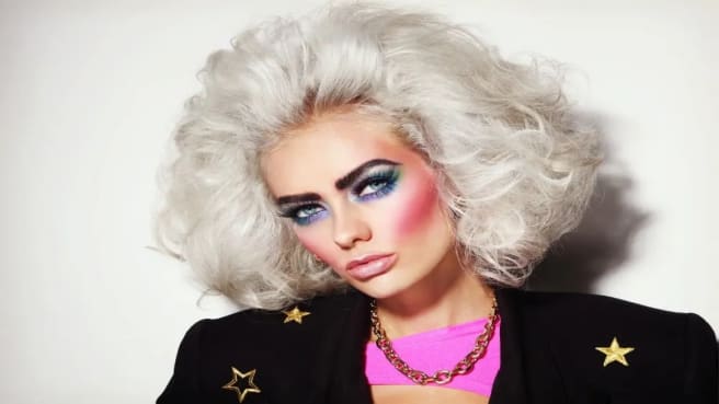 A woman dressed up as 1980 movie stars.