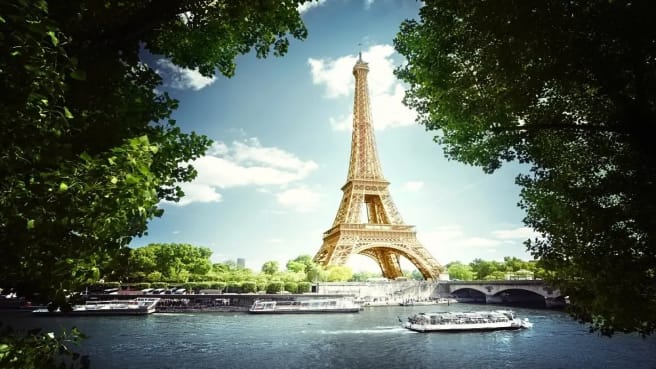 The Eiffel Tower in Paris, France, behind the trees.