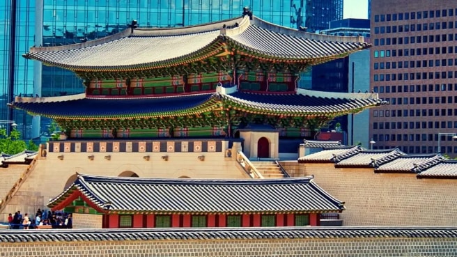 A traditional Korean building near modern buildings.