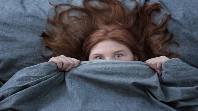 A teenager under the blankets - doesn't want to wake up.