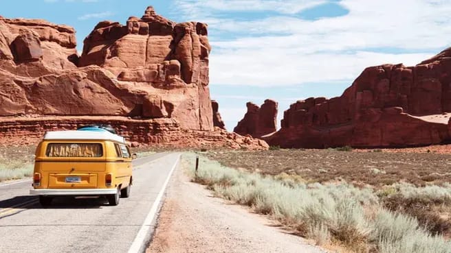 A big yellow old van traveling in a united states national park