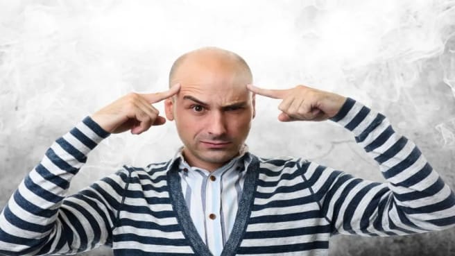 A funny man is thinking hard on the world's hardest quiz.