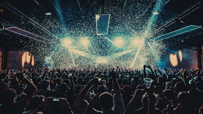 A music concert with a lot of crowd jumping and singing.