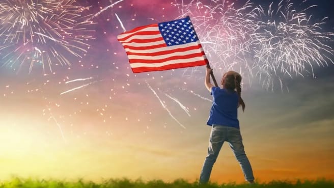A girl with US flag in the 4th of July holiday.