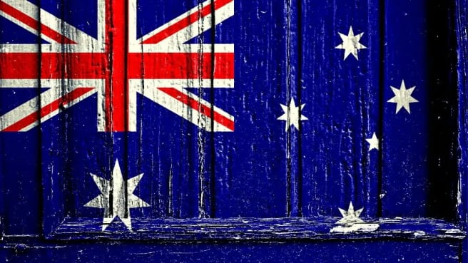 The Australian flag on a wooden wall.