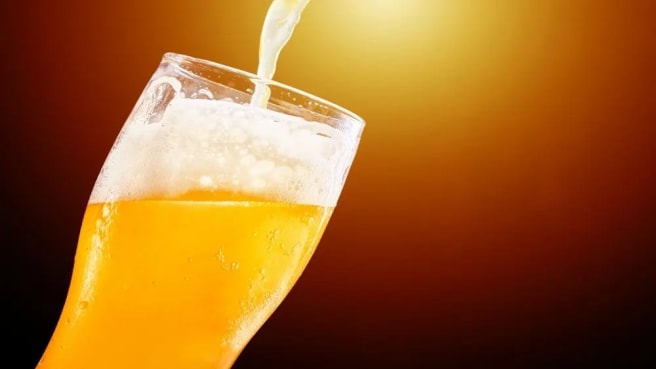 Beer is being poured into a special glass.