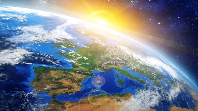 The sun is shining from space on Earth.