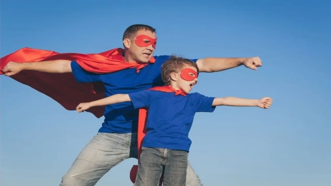 A father and his boy pretend to be superheroes on Father's Day.