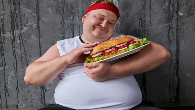 A funny man hugging his food.