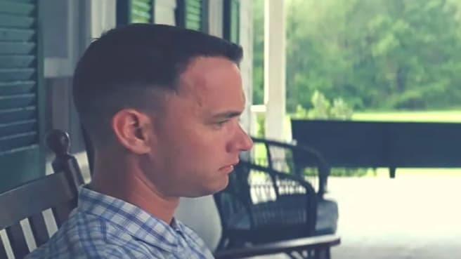 Forrest Gump sitting on the bench in his house.