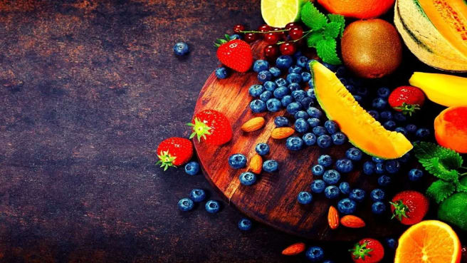 Colorful fruits on a black marble table.