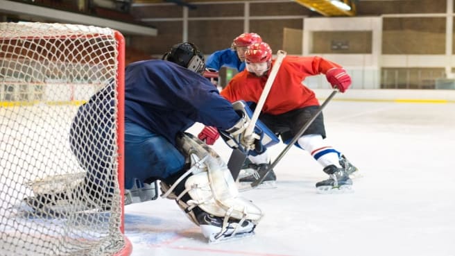 A Hockey (NHL) trying to score a goal.