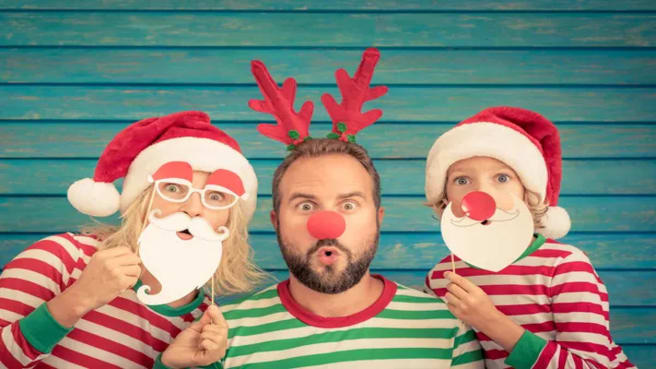 Christmas costumes - Funny father, mother and child on Christmas eve.