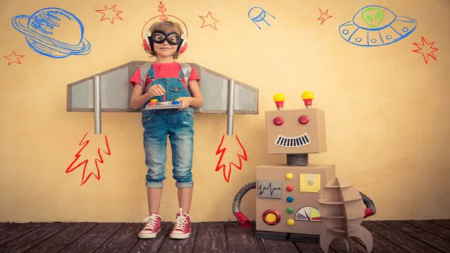 A Happy kid is playing with toy robots.