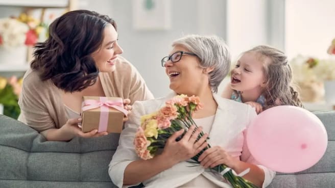 An older woman and her daughter and her granddaughter.