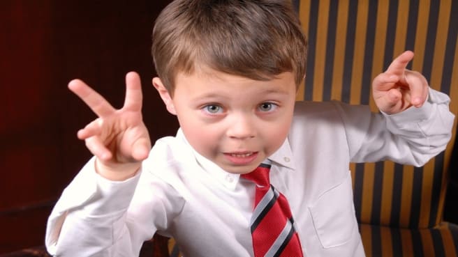 A funny kid dress-up up as a politician.