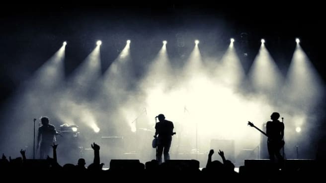 A Rock And Roll band playing on the stage.
