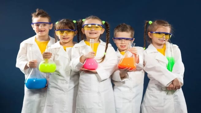 Five kids doing a small science experiment.