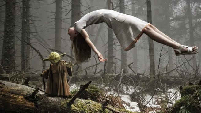 Yoda from star wars lifting a woman in the air.