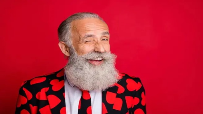 A funny old man wearing a suit with a heart for Valentine's Day.