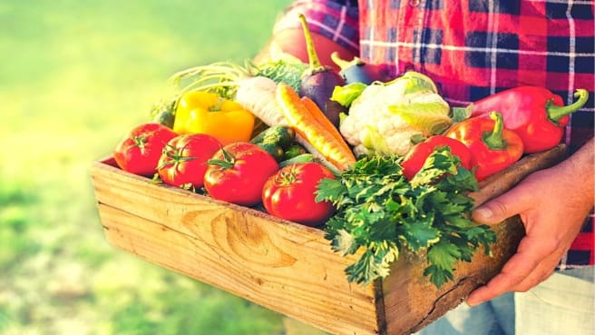 A man holds a vegetable box.