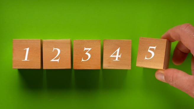 A man is completing a numerical series using reasoning.