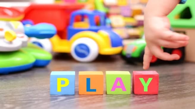 Play games with colorful toys and letters cubes.