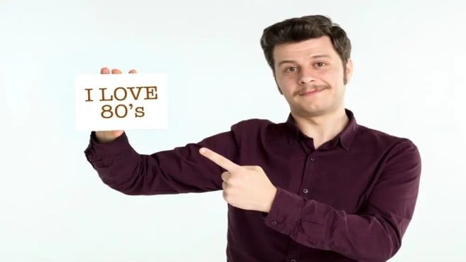 A man dressed in the 80s style, saying "I love the 80s".
