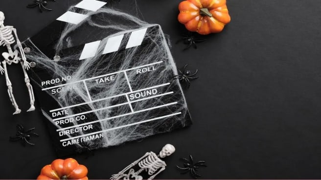 A movie film clapperboard styled for Halloween.