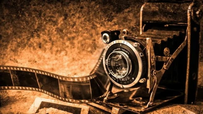 An old historic camera with a film.