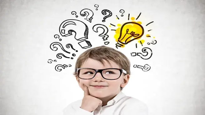 Adorable little boy wearing glasses and thinking, with many question marks and light bulb.