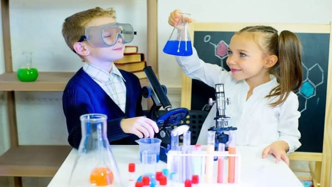 Two kids doing a small science experiment.