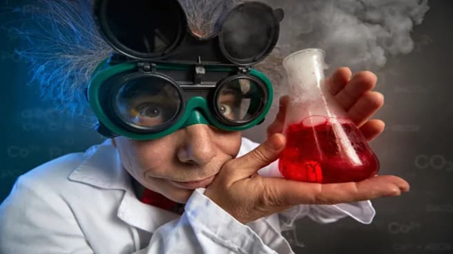 Funny scientist with protective glasses and test tube.