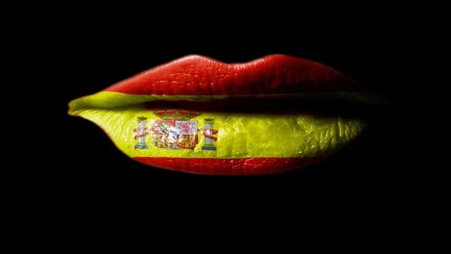 A woman lips painted with the Spanish flag.