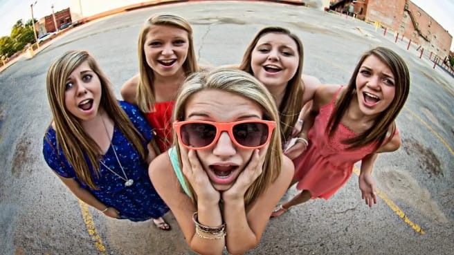 Funny teenage girls looking at the camera.