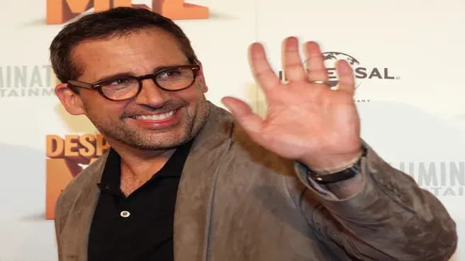 Steve Carell saying hi with his hand.