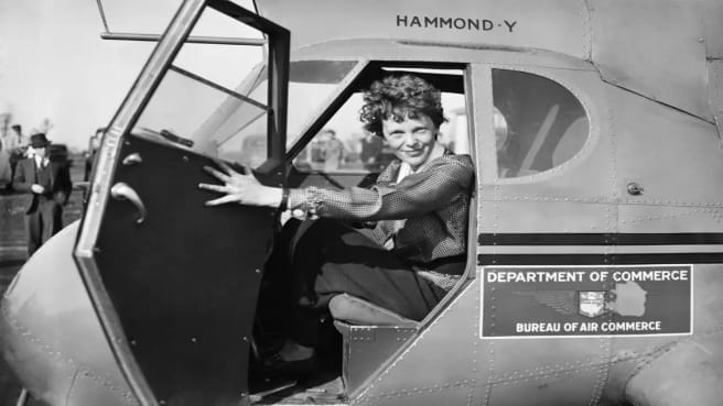 Amelia Earhart getting out of her plane. She is part of Women's history.