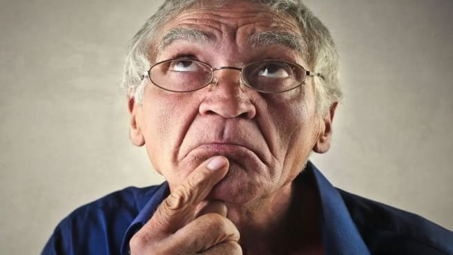 A funny old man is thinking hard on the world's hardest quiz.