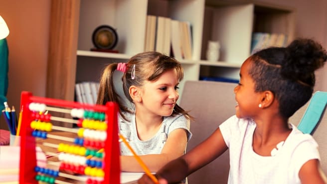 Two little girls solve a 3rd grader math question.