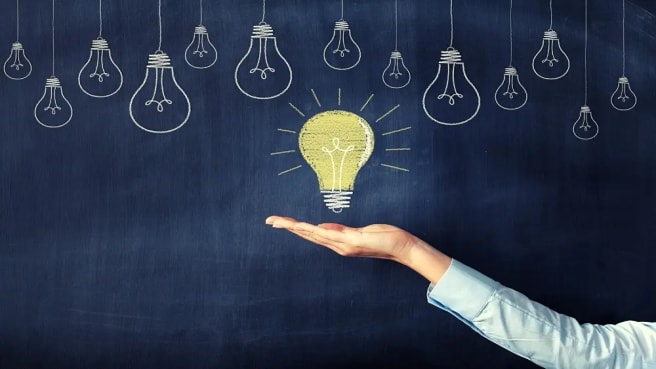 A light bulb of knowledge is painted on chalkboard.