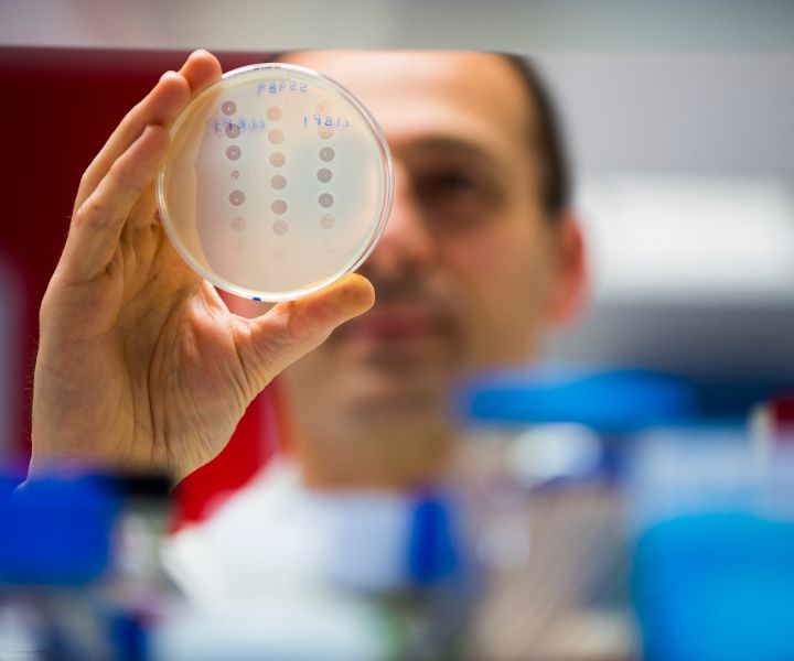 Male scientist with Petri dish in hand