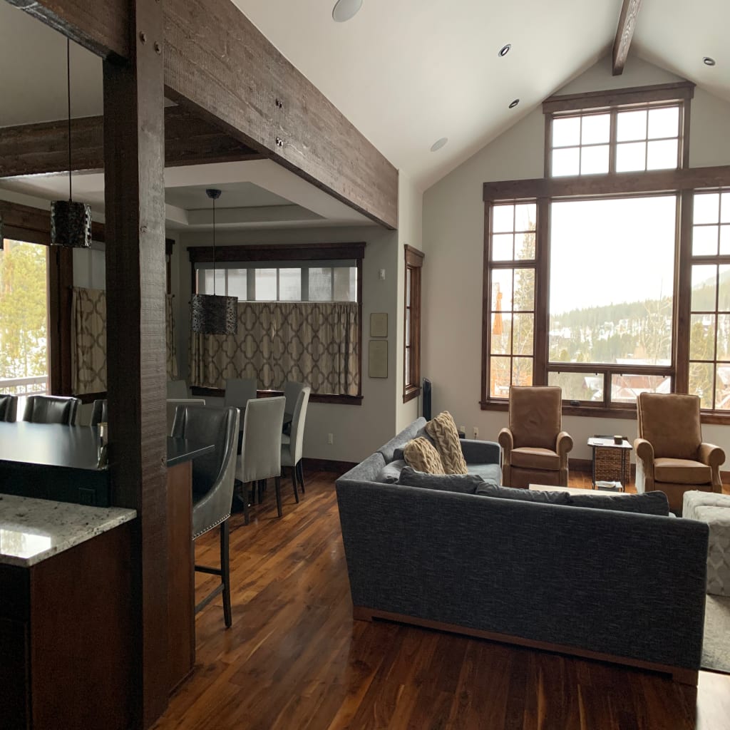 Open living and dining room with large windows and coordinated shared spaces
