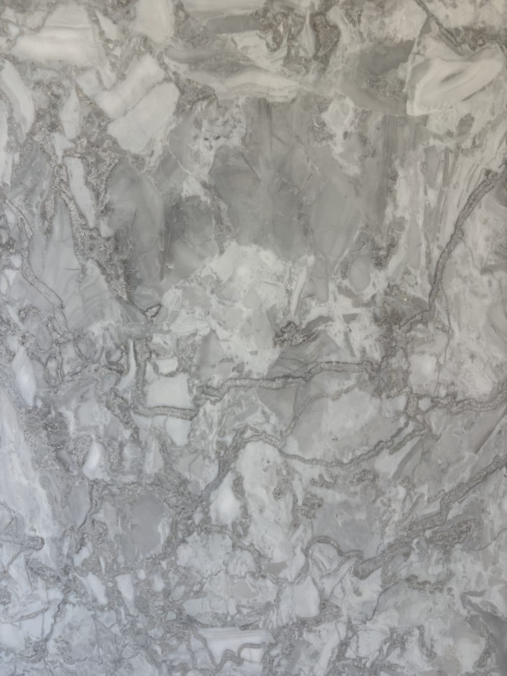 Alba Pietra dolomite detail, soft grey cloud movement broken by a network of fine crystalline veining