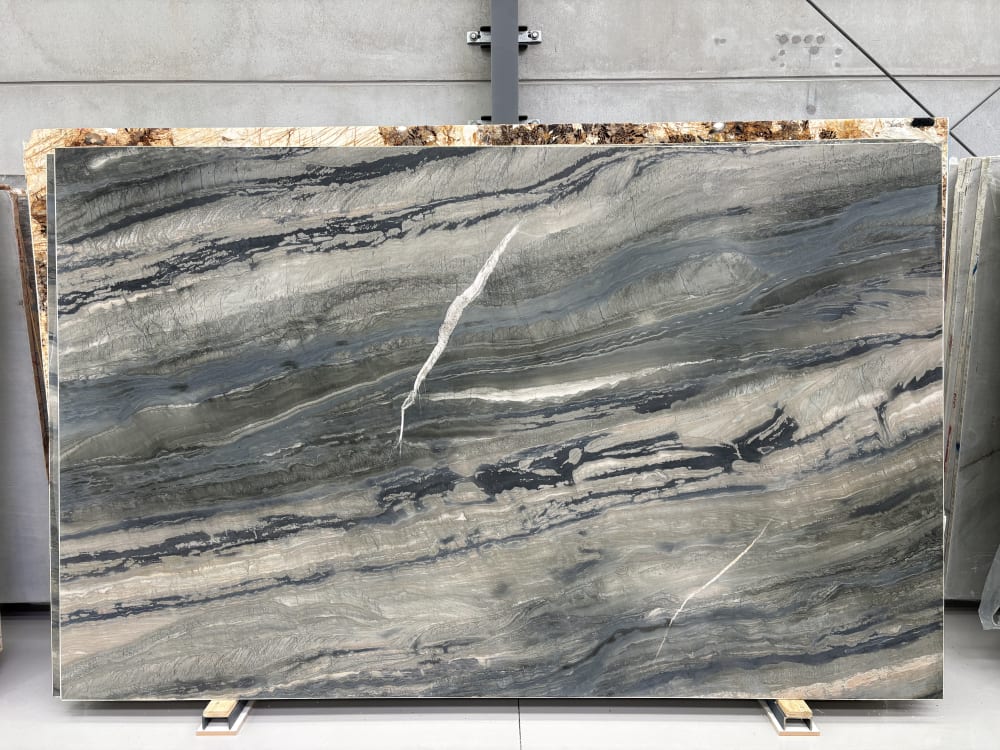 Galapagos quartzite full slab, honed dark charcoal-grey with dramatic linear movement and a bold white vein