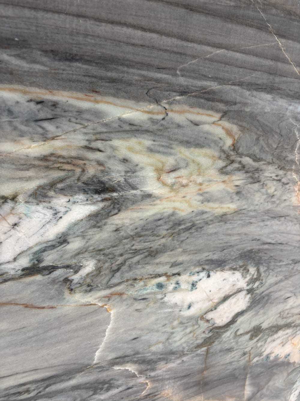 Ocean Blue quartzite detail, sweeping grey movement opening into warm gold veining