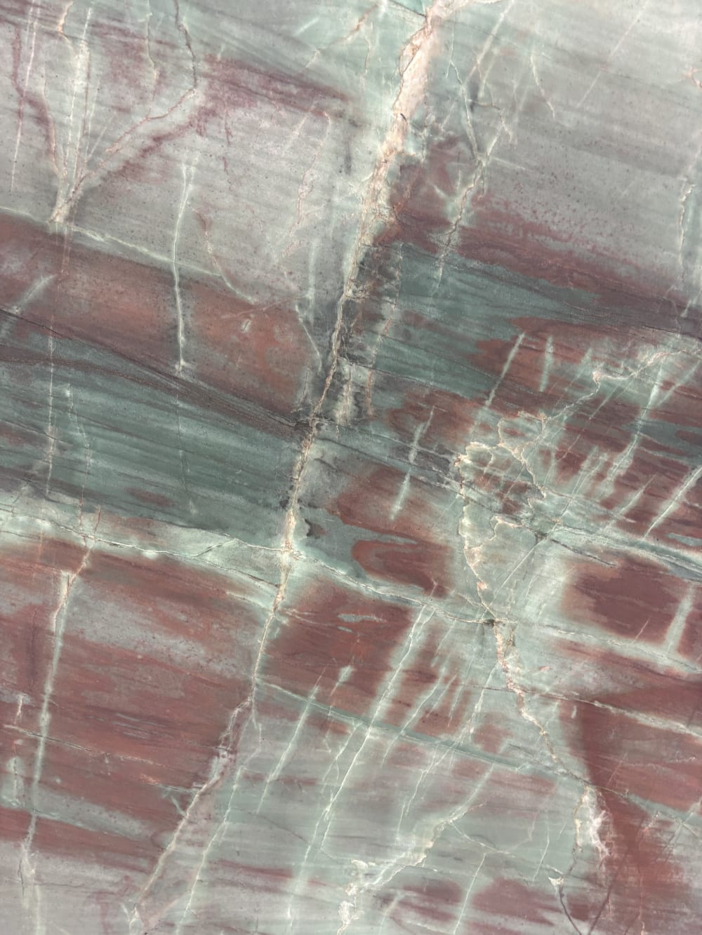 Green Valley quartzite detail, burgundy-red veining crossing a deep green striated ground