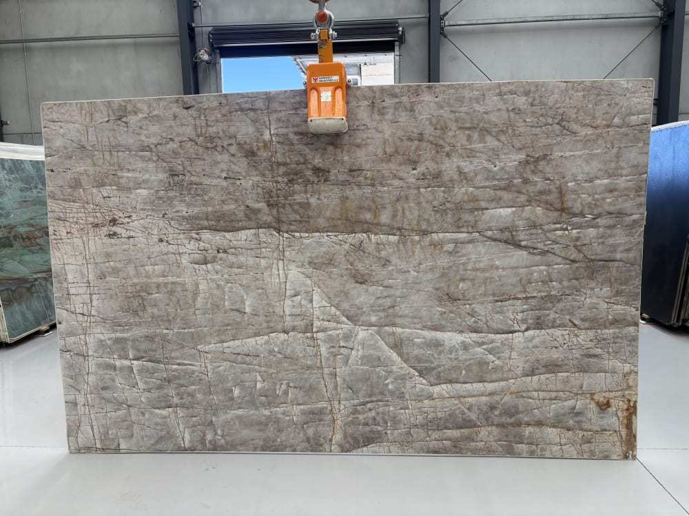 Valentine Crystal quartzite full slab, honed cool grey-taupe with fine rust-red hairline veining