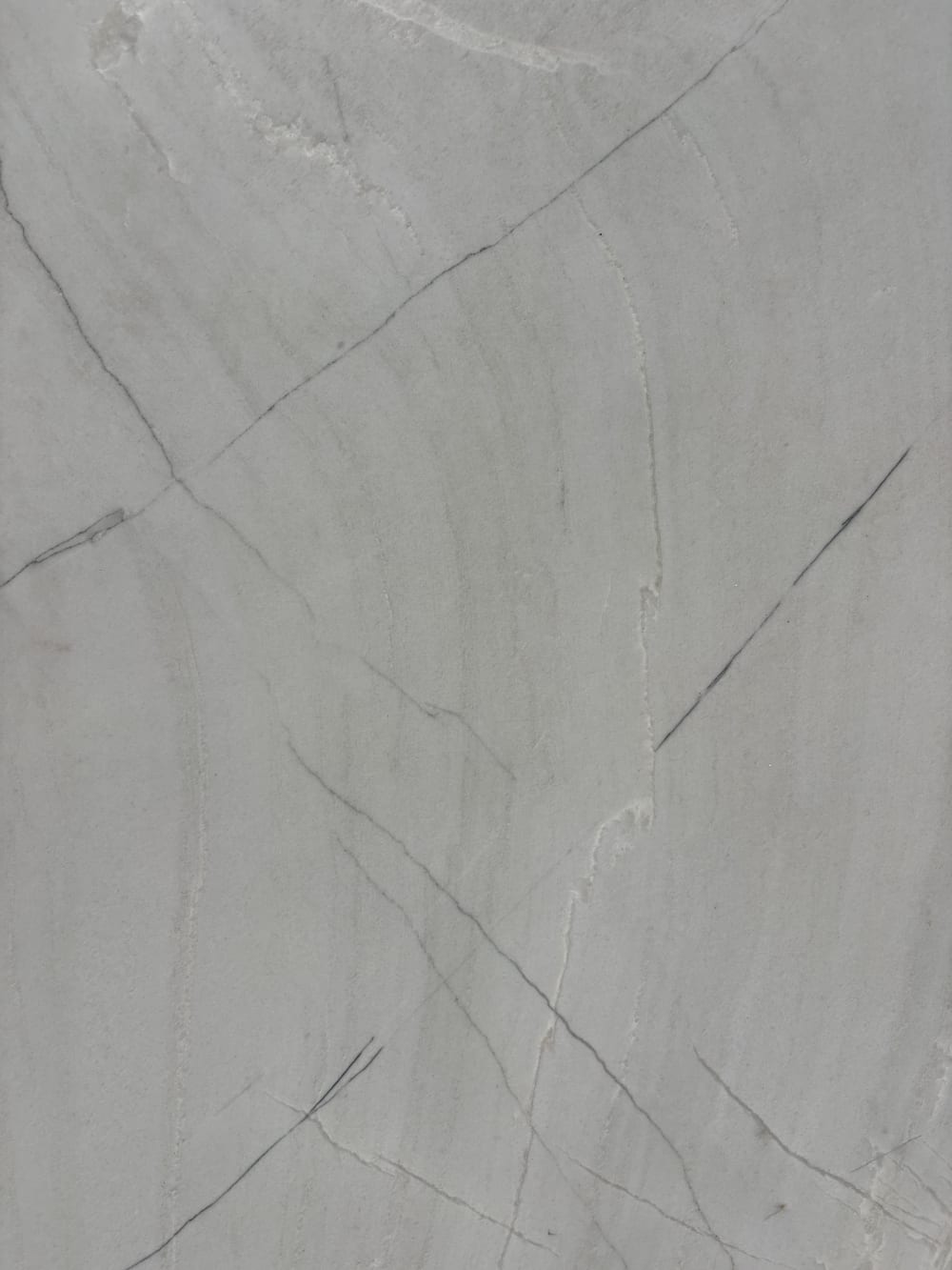 White Santorini quartzite detail, gentle linear directional movement in soft white-grey stone