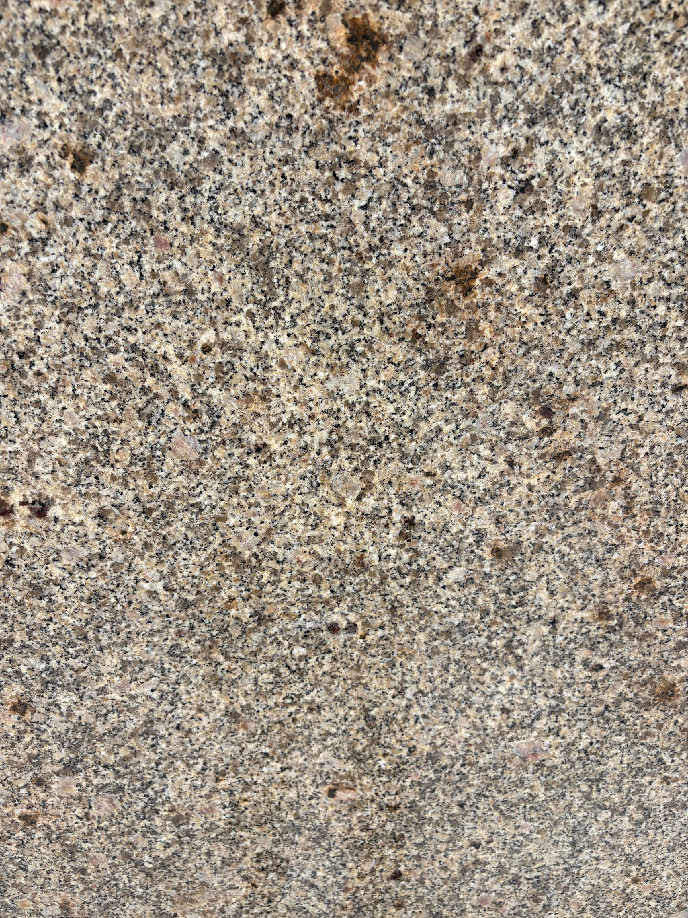 Amarillo Cathedral granite block 2952 detail, warm gold and charcoal grain with rust-brown flecks under a polished finish