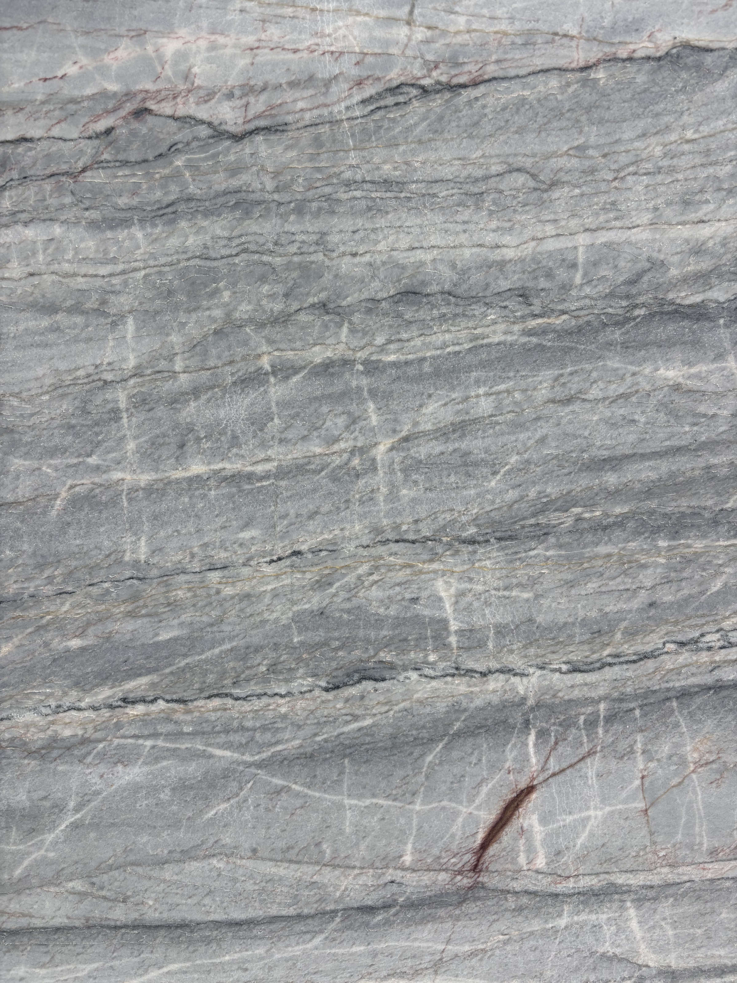 Essenza Blue quartzite block 13879 detail, blue-grey linear striations with fine rust-red veining